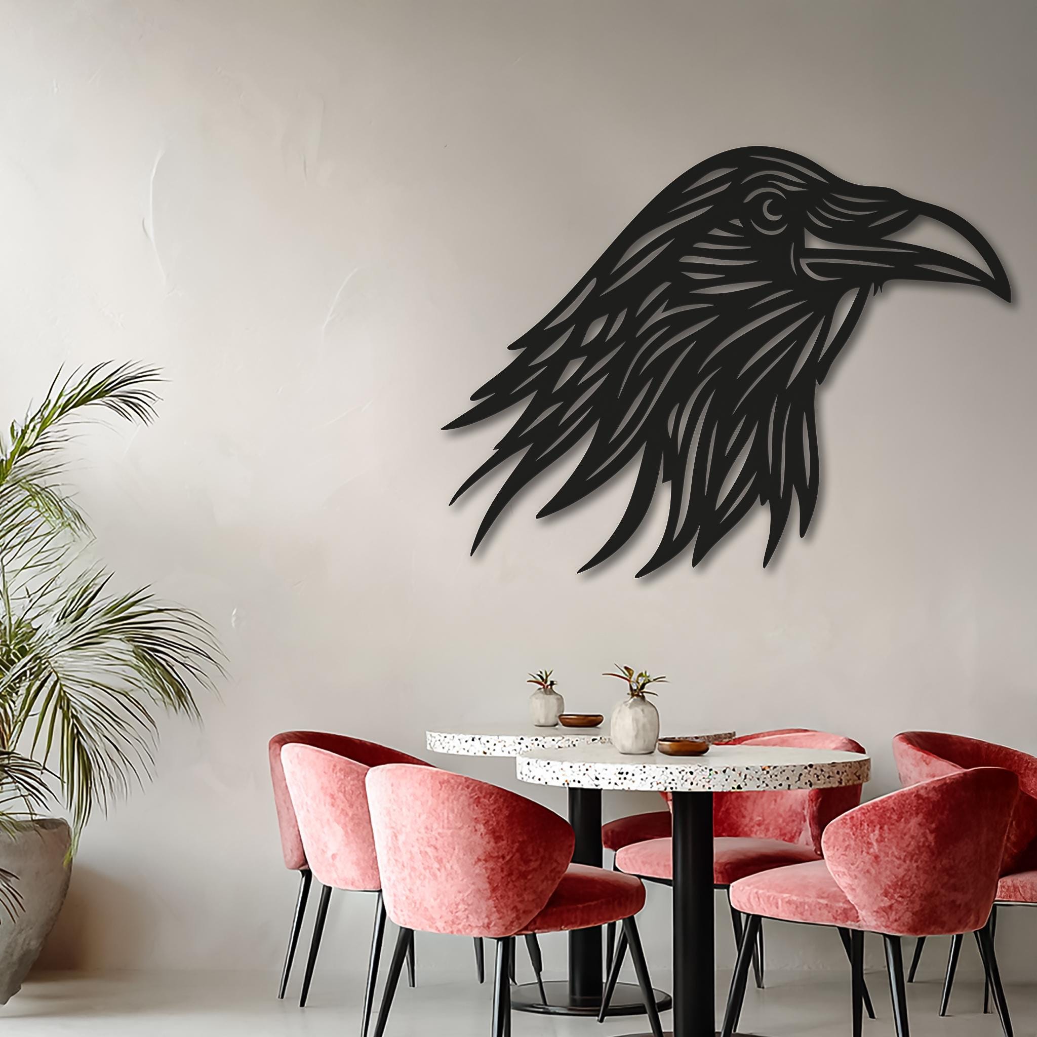 Woman holding raven metal wall art for size reference, CNC cut black steel crow head, handmade powder-coated, available in multiple sizes, customizable text option.