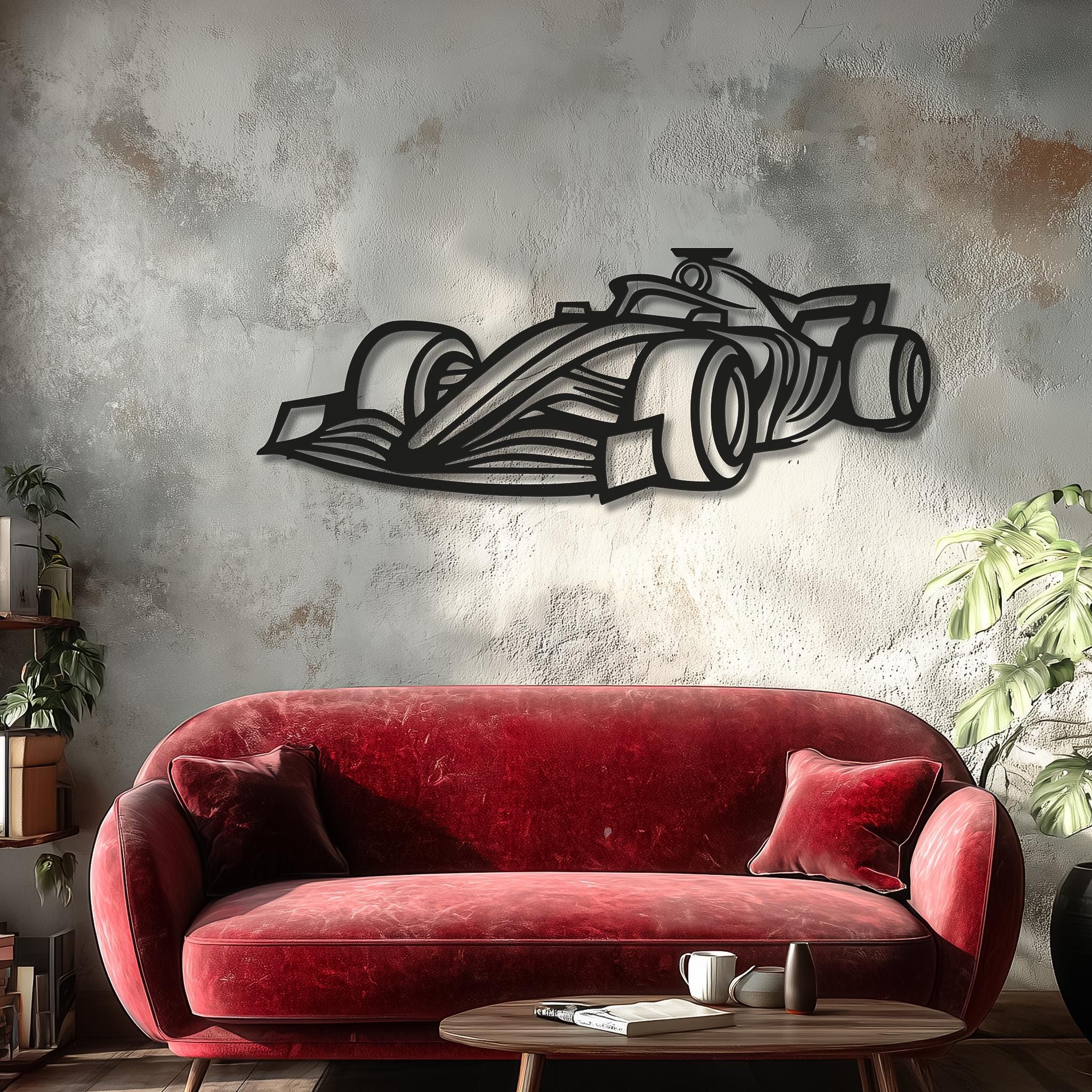 Open-wheel race car metal wall art in matte-black above a deep red sofa; textured concrete wall and natural light create dramatic 3D shadow. Statement motorsports racing decor; customizable number or name; perfect gift for motorsport lovers, ready to hang.