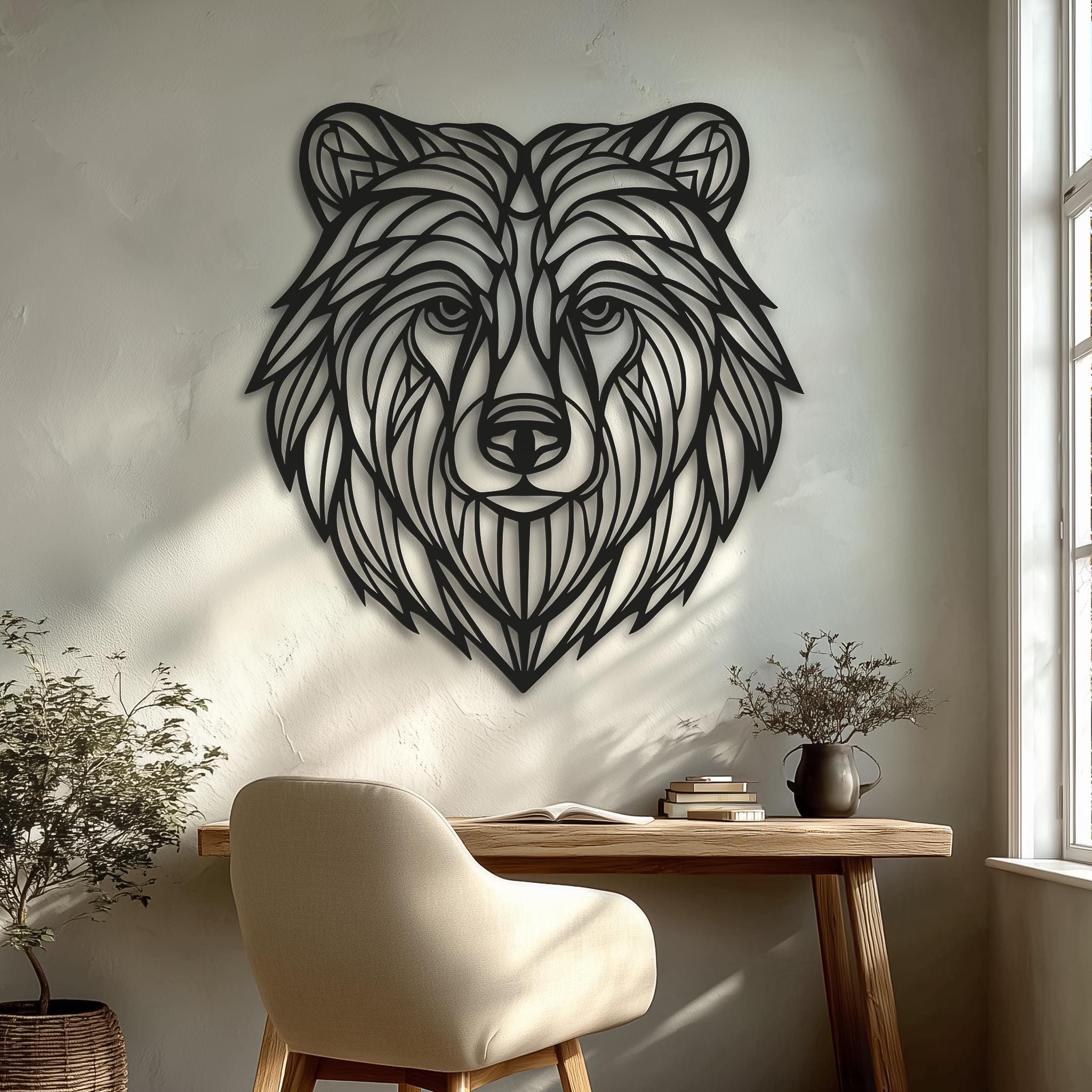 CNC laser-cut bear head metal wall art on clean white wall with soft window light; black powder-coated line art, minimalist home office or living room decor; handmade modern cabin or lodge gift.