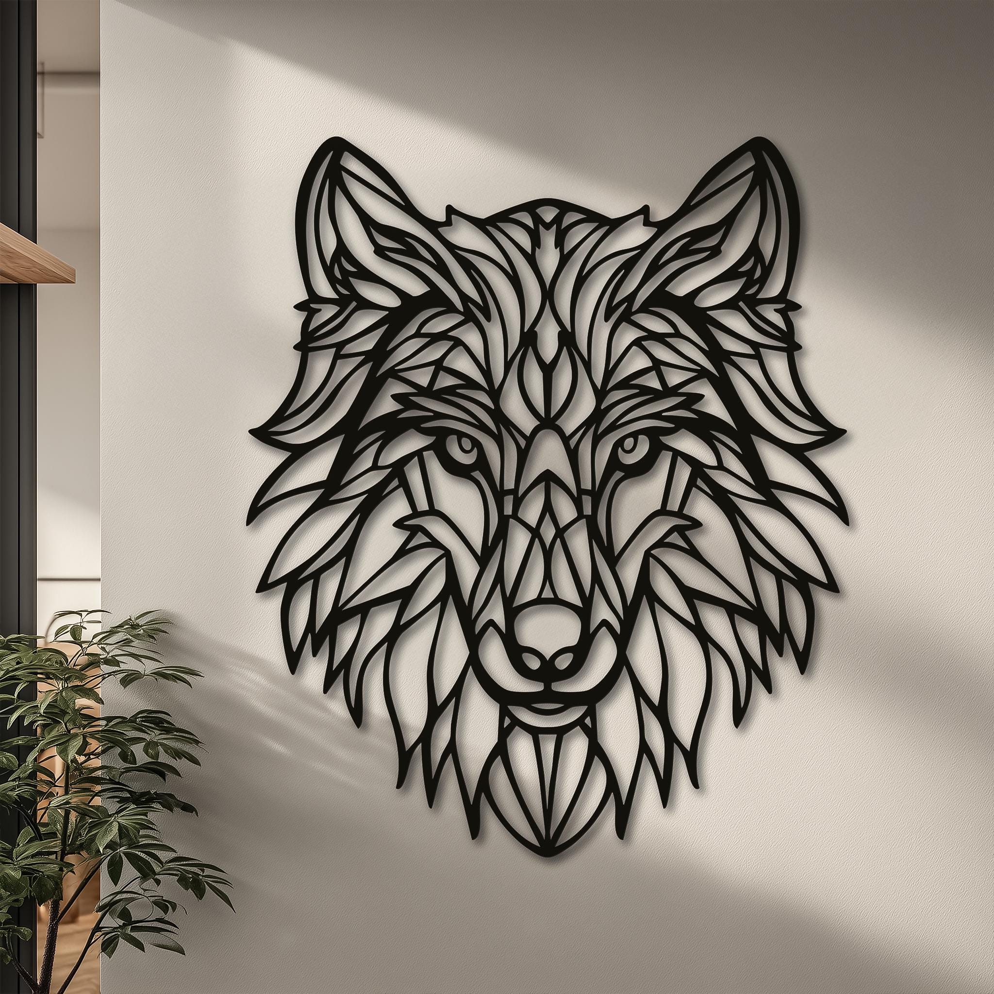 Geometric wolf head metal wall art hanging on a bright, textured wall. The modern lines of the black metal design perfectly complement minimalist and Scandinavian style decor. A chic wildlife-themed wall decoration for a living room or office.