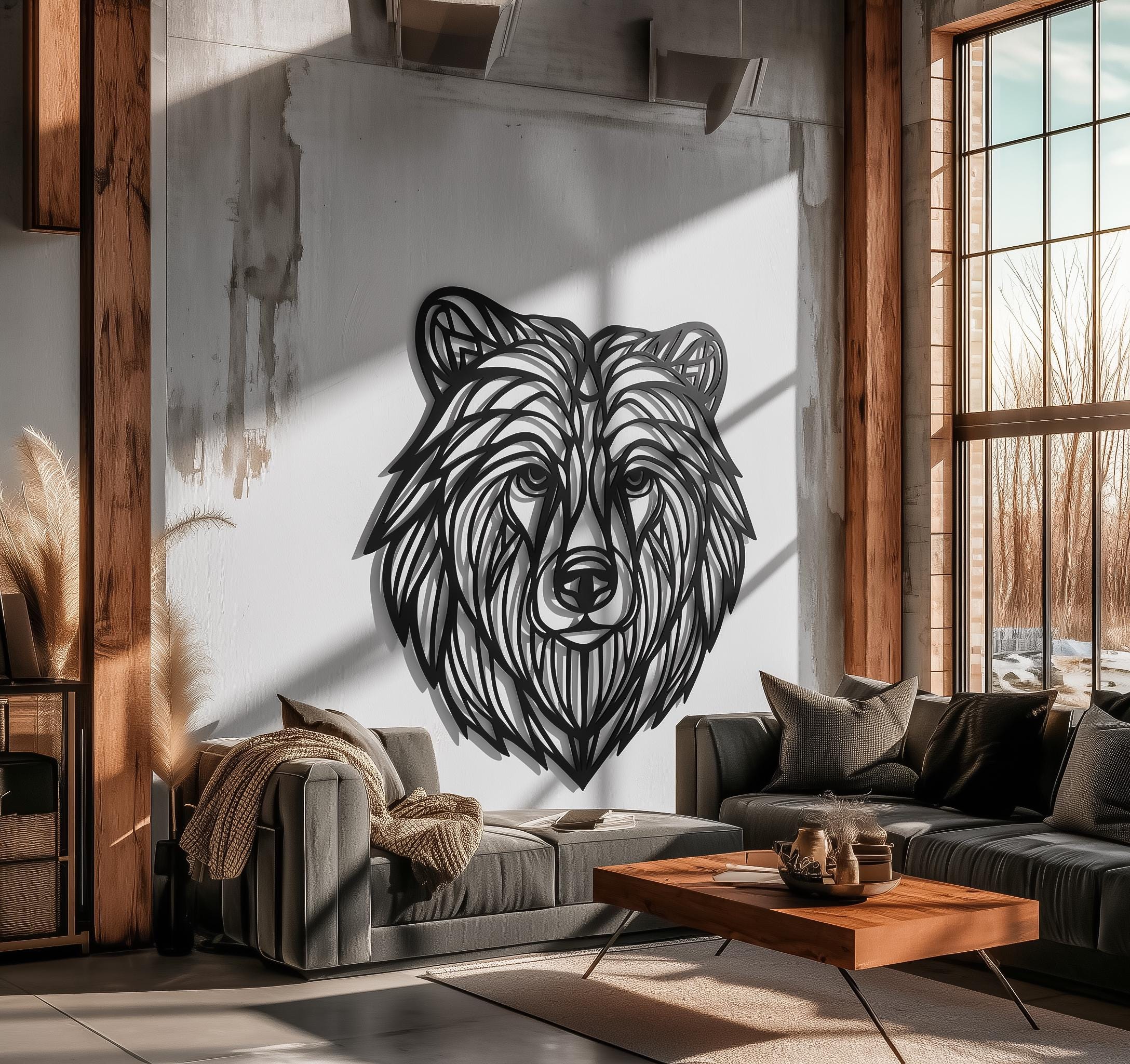 Loft living room with sunlight and beams showcasing a large CNC laser-cut bear head metal wall art on white wall; black powder-coated line art sculpture; industrial modern decor, handmade.
