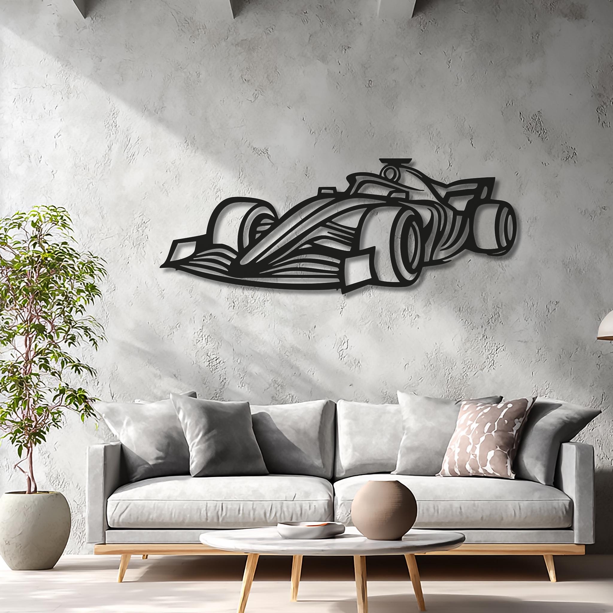 Modern living room with light-gray sofa and matte-black open-wheel race car wall art. CNC laser-cut for crisp lines and 3D shadow. Motorsports racing décor gift; personalize with name or race number; available in multiple sizes; ready to mount.