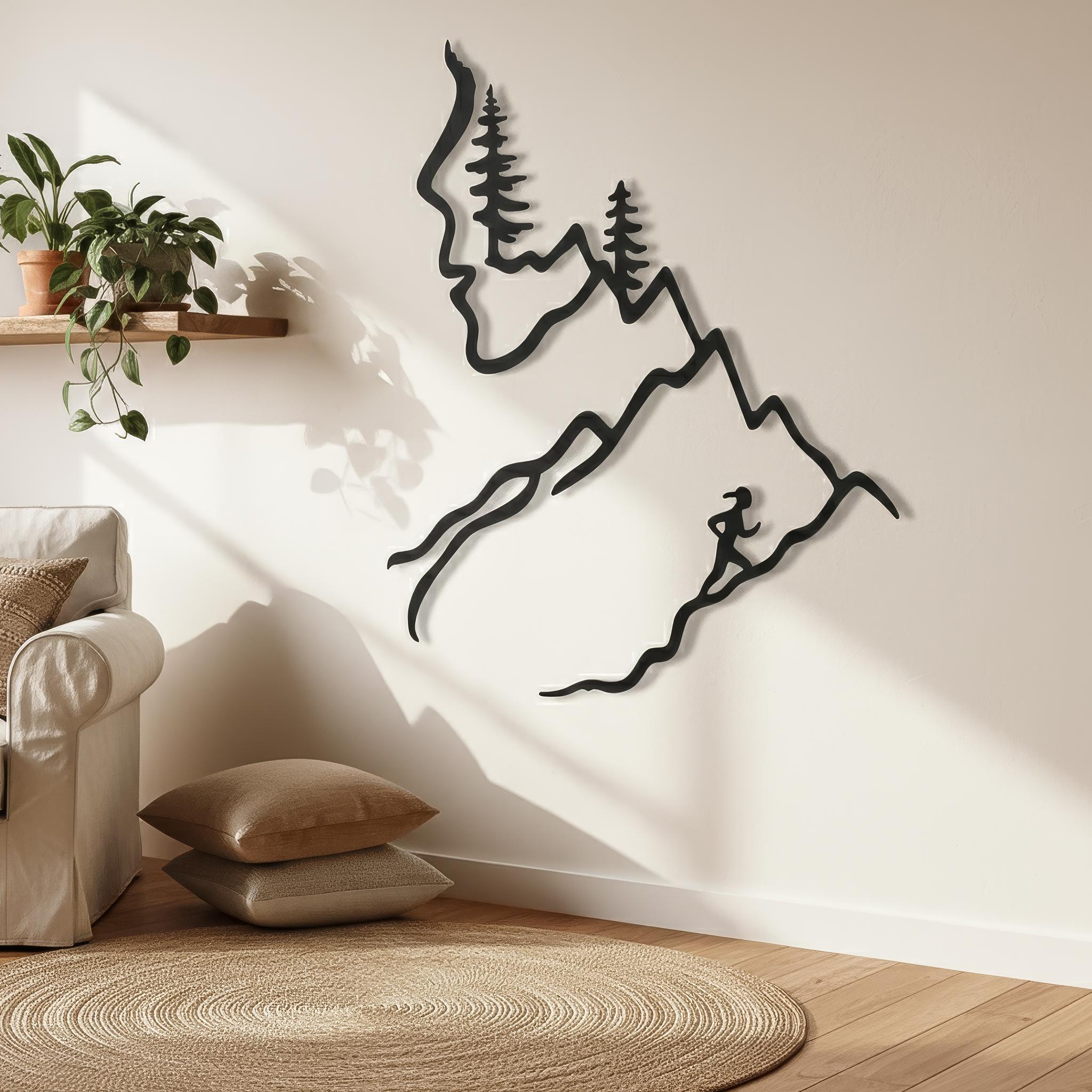 Mountain trail running metal wall art with woman runner silhouette in cozy boho corner with plants and jute rug, motivational running wall art and gifts for runner.