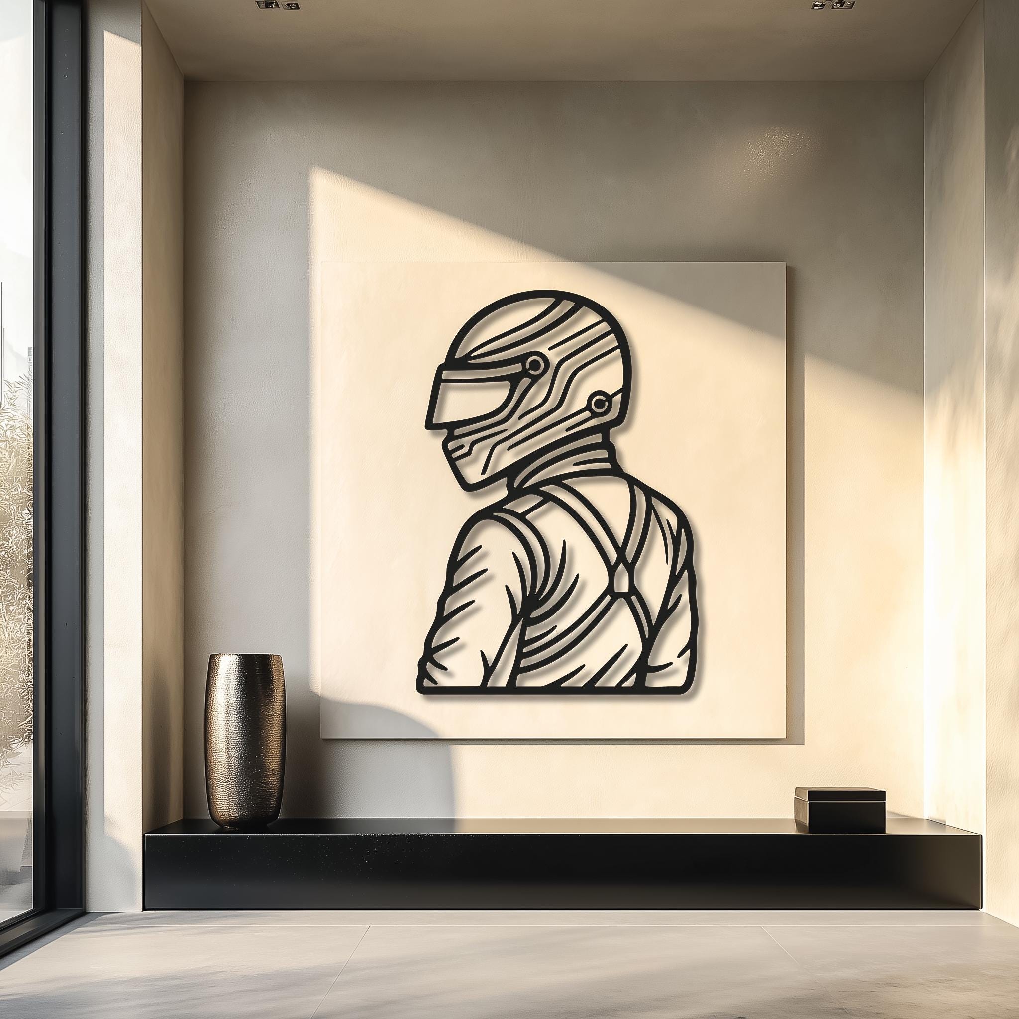 Gallery-style motorsports driver silhouette on a panel; CNC laser-cut metal in matte black; natural sunlight adds depth; statement piece for entry or office; multiple sizes available; perfect gift for racing lovers; ready to hang, powder-coated for durability.