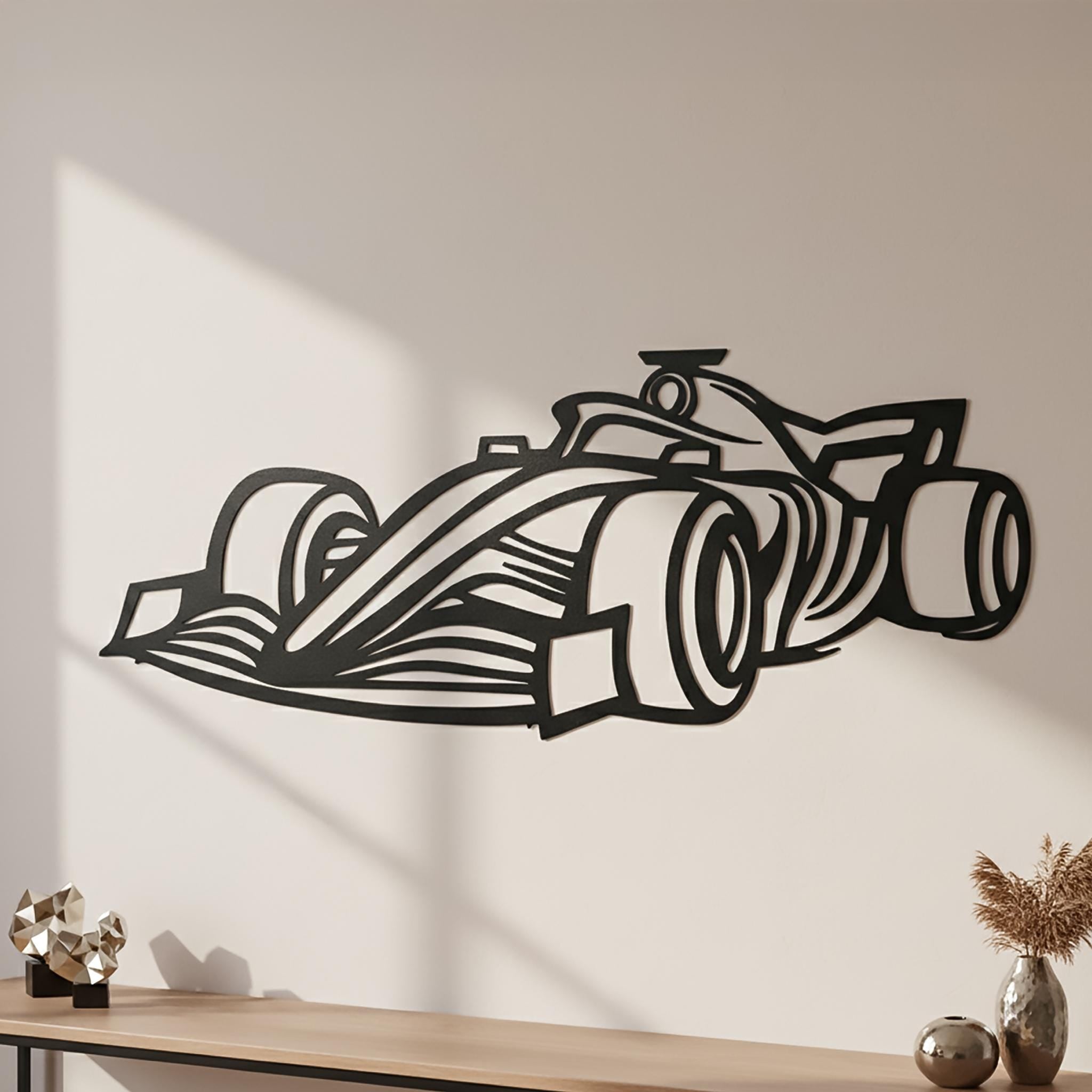 Close-up view of matte-black open-wheel race car metal wall art on a warm beige wall; strong 3D shadow and clean edges. Premium motorsports racing décor for shelf or console areas; customizable with name or number; ready to hang.