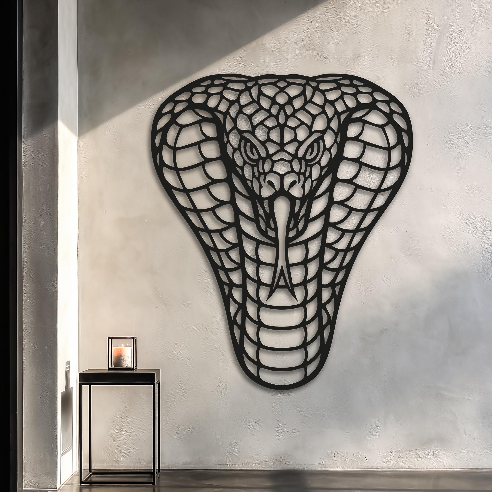 Large cobra metal wall art on a light textured wall; black powder-coated, laser-cut steel; modern minimal alcove scene with natural sunlight and soft shadows; premium statement piece for living room, hallway or office; XL wall decor for bold interiors; gift for reptile lovers