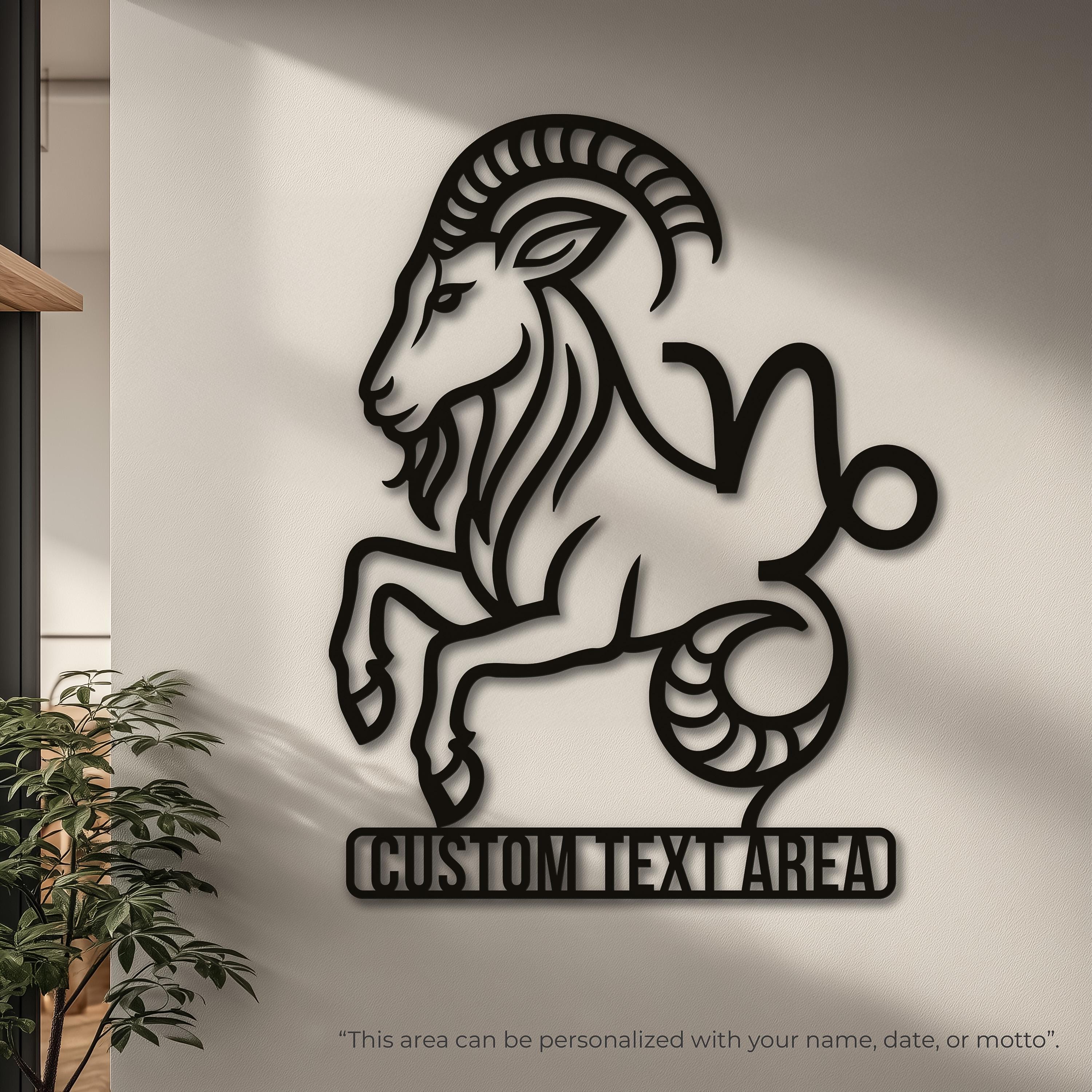 May include: A black wall-mounted cutout of the Capricorn zodiac symbol, featuring the stylized head and horns of a goat transitioning into a curled fish tail. The design is a flat, continuous silhouette with clean, sharp edges and no internal details.