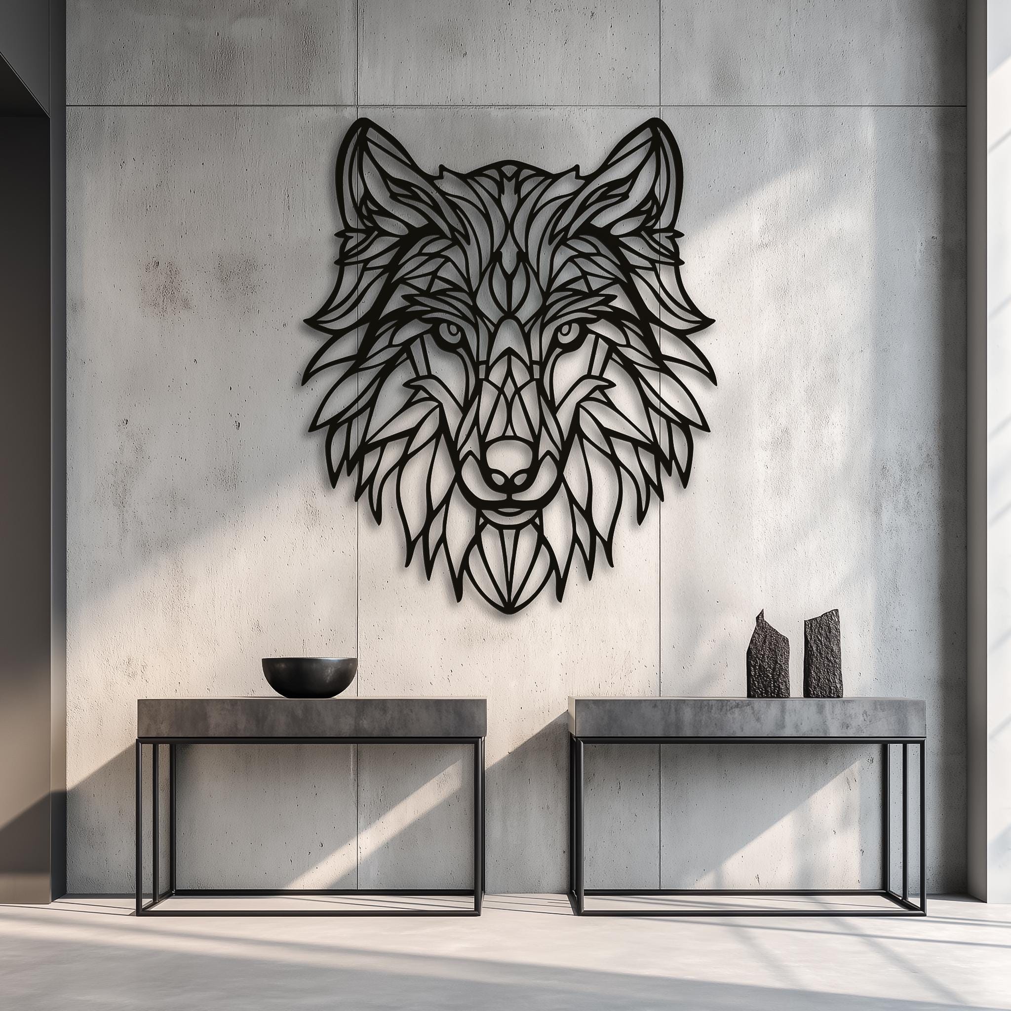 Black metal wolf head art hanging on a raw, concrete-look wall in an industrial loft-style space. Highlighted by spotlights, this masculine and powerful design is perfect for a modern man cave, office, or rustic cabin decor.