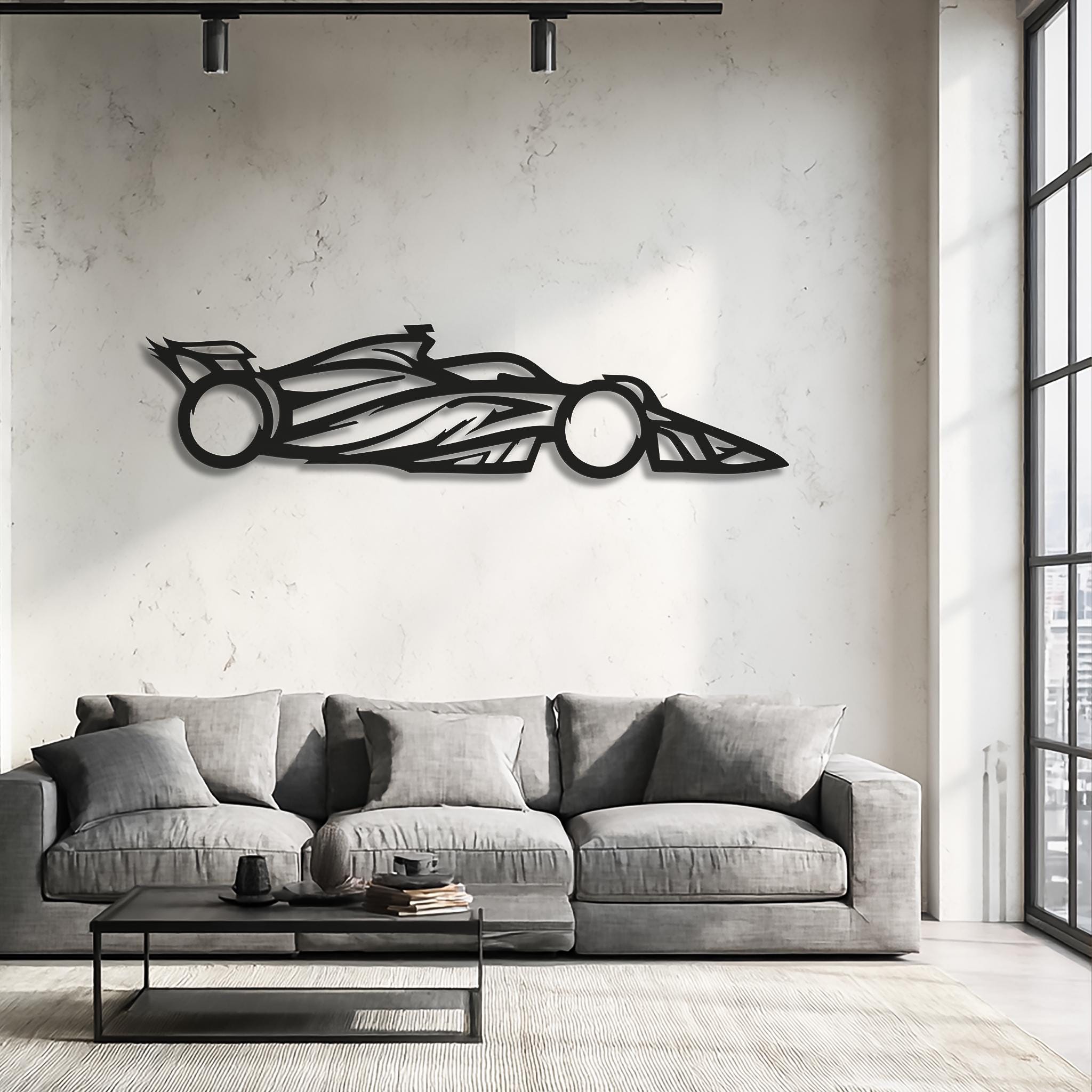 Open-wheel motorsports racing car silhouette metal wall decor above a modern sofa; CNC laser-cut matte black, lightweight shadow effect; living room or game room; unique gift for racing fans.